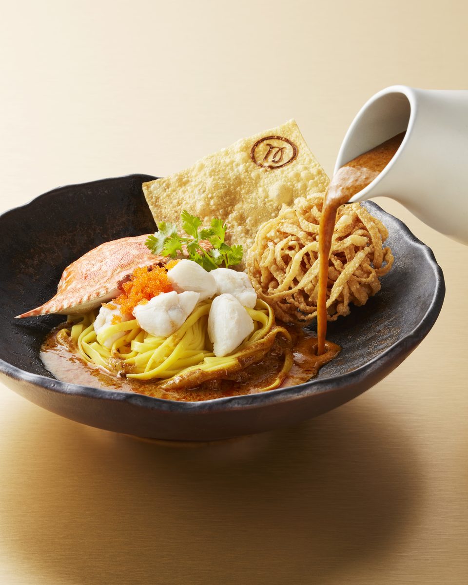 Khao soi with blue swimmer crab, the curry poured over egg noodles and crisp noodles