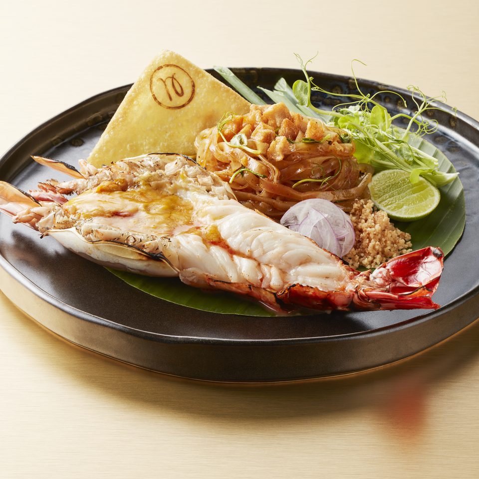 Dry khao soi beside a grilled river prawn